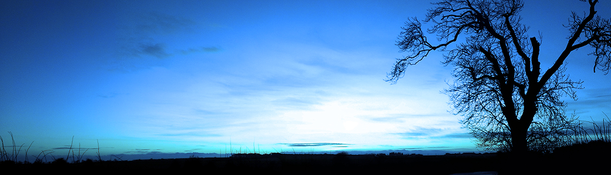 Panoramic view across countryside towards the Northumberlnad coast with blue filter on image